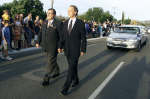 John Bradman (R), son of Sir Don, and funeral director David Lloyd escort the hearse carrying the body of Sir Don