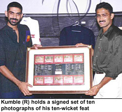 Kumble (R) holds a signed set of ten photographs of his ten-wicket feat