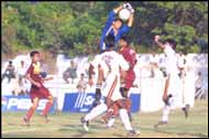 Bengal 'keeper Imran Khan collects from a corner by Karnataka's Xavier Vijaya Kumar 